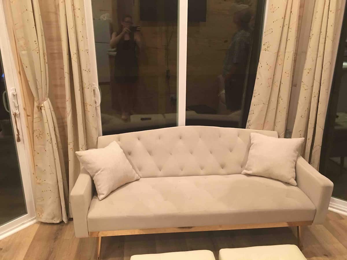 Tufted loveseat by the window